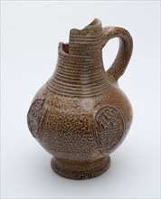 Brown speckled stoneware jug be worn with rings around the neck, three decorated medallions on the belly, jug crockery holder