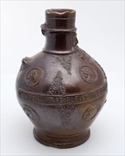 Dark brown bearded jug, round belly frieze with text, portrait medallions and acanthus leaves, beard masonry vessel holder soil