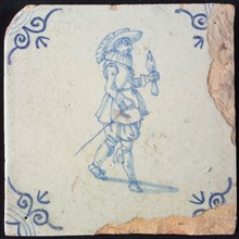 White tile with blue warrior with bird on arm and plume hat; corner pattern ox head, wall tile tile sculpture ceramic