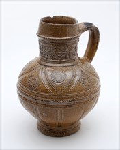 Brown stoneware jug be arranged with frieze around the neck, flower rosettes imprinted on the shoulder and flutes, jug crockery
