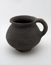 Dark gray earthenware cooking jug with sausage ear, on six fins, rotating on shoulder, cooking jug be found in the earthenware