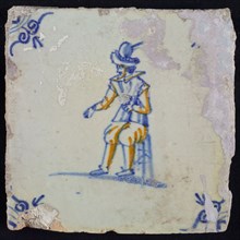White tile with yellow and blue soldier on stool, ox-head corner motif, wall tile tile sculpture ceramics pottery glaze, baked