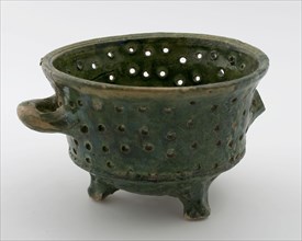 Small pottery colander, white shard with green lead glaze, two horizontal sausage ears, on three legs, colander kitchen