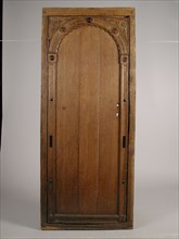 Room door with carving in frame, door frame building part wood oak, sawn planed cut Oak room door in frame The door