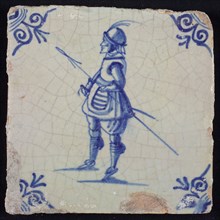White tile with blue warrior with spear and helmet; corner pattern ox head, wall tile tile sculpture ceramics pottery glaze