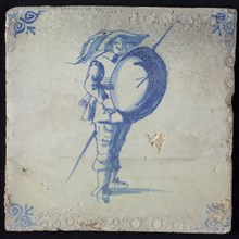 White tile with blue warrior with lance and shield; corner pattern ox head, wall tile tile sculpture ceramic earthenware glaze