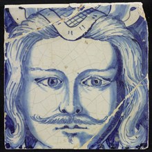Tile of chimney pilaster, blue on white, head of man with long curly hair and mustache, beginning of shell-shaped headdress