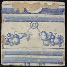 Tile of chimney pilaster, blue on white, above and below two blue horizontal bands, in between fruit pieces hanging on wire