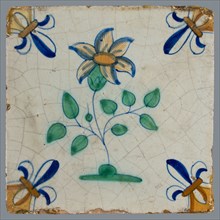 Tile, flower on ground in yellow, brown, orange, green and blue on white, corner pattern french lily, corner point yellow, wall
