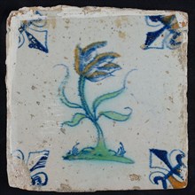 Tile, flower on ground in yellow, orange, green and blue on white, corner pattern french lily, corner point orange, wall tile
