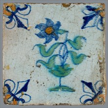Tile, flower on ground in orange, green and blue on white, corner pattern french lily, corner point orange, wall tile