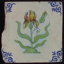 Tile, flower on spot in yellow, brown, green and blue on white, corner motif oxen head, wall tile tile sculpture ceramic