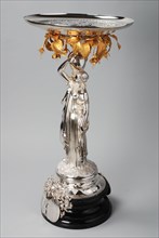 Fa. Van Kempen, Silver centerpiece, female figure on ebony base, carrying silver bowl: Minerva with the nine muses, table holder