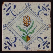 Tile, tulip on ground in orange, green, purple and blue on white, inside serrated square with plume, corner pattern french lily
