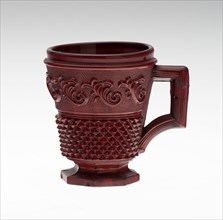 Cup with Handle, c. 1850, England, Glass, opaque red with relief decoration, H. 7.5 cm (2 15/16 in