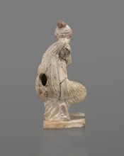 Terracotta figurine of a girl throwing dice. Figurine of a crouching girl throwing dice: weight of