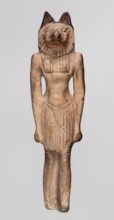 Amulet — Anubis. Anubis is depicted as a striding man with the head of a dog Canidae. Arms hang at