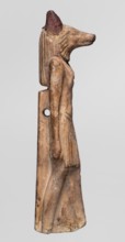 Amulet — Anubis. Anubis is depicted as a striding man with the head of a dog Canidae. Arms hang at