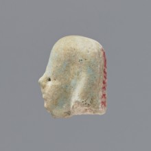 Fragment of a shabti;, Head of a shabti figurine with indistinct facial features, in a smooth wig.