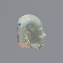 Fragment of a shabti. Head of a shabti figurine with carefully rendered facial features, in a
