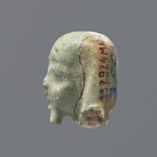 Fragment of a shabti. Head of a shabti figurine with rather carelessly rendered facial features, in