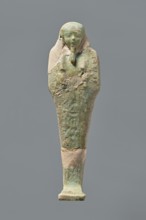 Ushabti, Mummy-shaped figurine, standing on a base with the back resting on a pillar. Arms crossed