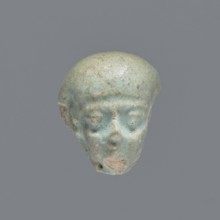 Fragment of a shabti; mummy-shaped funerary figurine. Head of a shabti figurine with carefully