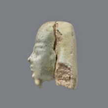 Fragment of a shabti. Head of a shabti figurine with carefully rendered facial features; smooth