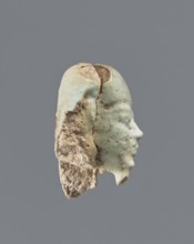 Fragment of a shabti. Head of a shabti figurine with carefully rendered facial features; smooth wig