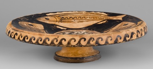 Red-figure plate depicting fish; plate with an inwardly curled edge. Interior painted with four