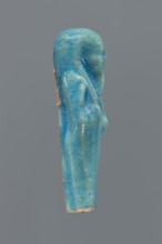 Shabti, Mummy-shaped figurine, back supported by a pillar/pilaster. Legs missing up to knee height.