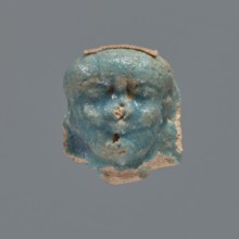 Shabti head, mummy-shaped figurine, funerary gift. Head of a shabti figurine depicting a king: oval
