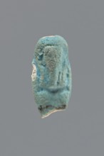 Shabti, Mummy-shaped funerary figurine, legs missing. Arms crossed on the chest, hands invisible