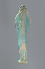 Ushabti, Mummy-shaped figurine standing on a base with a flat pillar at the back. Arms folded