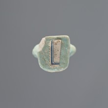 Shabti, Mummy-shaped figurine, standing on a base; head missing. A narrow, slightly convex pillar