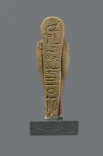 Shabti, mummy-shaped figurine, funerary gift. Mummy-shaped figurine standing on a base, back