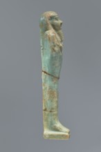Ushabti, Mummy-shaped figurine shabti. Standing on a base with a flat pillar behind it. Arms folded