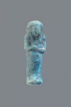 Ushabti, Mummy-shaped figurine impressed in a mold, carelessly made of faience; back flat and