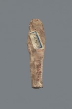 Shabti, Mummy-shaped figurine, funerary gift, made carelessly, impressed in a mold. Hands folded on