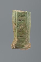 Shabti legs, mummy-shaped figurine fragment knees down. Feet rest on a base with a flat pillar at