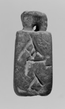 Christian amulet with Greek inscription. Limestone amulet in the shape of an elongated hexagon.