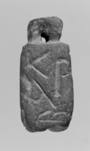 Limestone Christian amulet in the shape of an elongated hexagon with Greek inscription. Text in