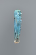 Ushabti, Mummy-shaped figurine, back supported on a flat pillar. Feet missing. Arms crossed on the