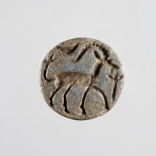 Conical stamp seal with a hole drilled below the top of the cone. On the circular base is engraved