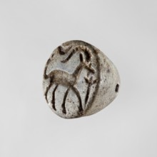 Conical stamp seal with a hole drilled below the top of the cone. On the circular base is engraved