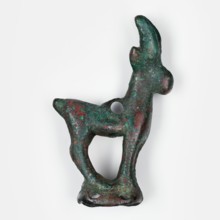 Figurine of an ibex standing on a base in the form of a hollow prism, with two pairs of holes on