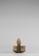 A miniature kyatos with a flat bottom and a bowl whose walls widen diagonally almost halfway up and