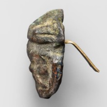 Appliqué in the shape of Silenus's head, The head of a bearded Silenus wearing a round cap with two