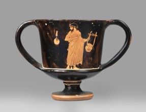 Red-figure kantharos with a depiction of an ephebe with an aryballos and a Greek inscription