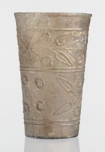 Glass decorated with a leaf and fruit motif; transparent, colorless glass with relief decoration in